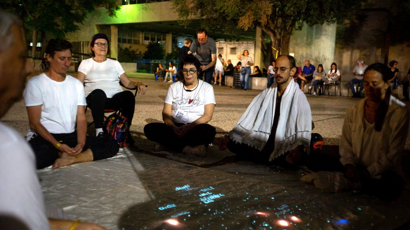 A meditation circle around the installation at the hostage vigil at Tel Aviv Museum square